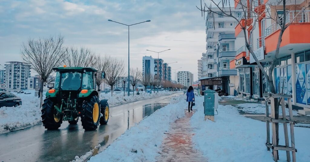 A tractor is moving on icy road.