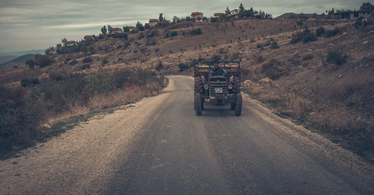 A tractor is moving on the road