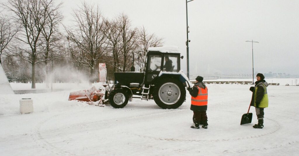 tractor is removing snow from road